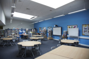 Photo of the library inside Longfield Academy, showing the tables and chairs in the foreground.