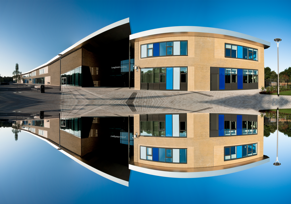 Vertically mirrored image of the outside of the Longfield Academy building, showing the entrance to the left.