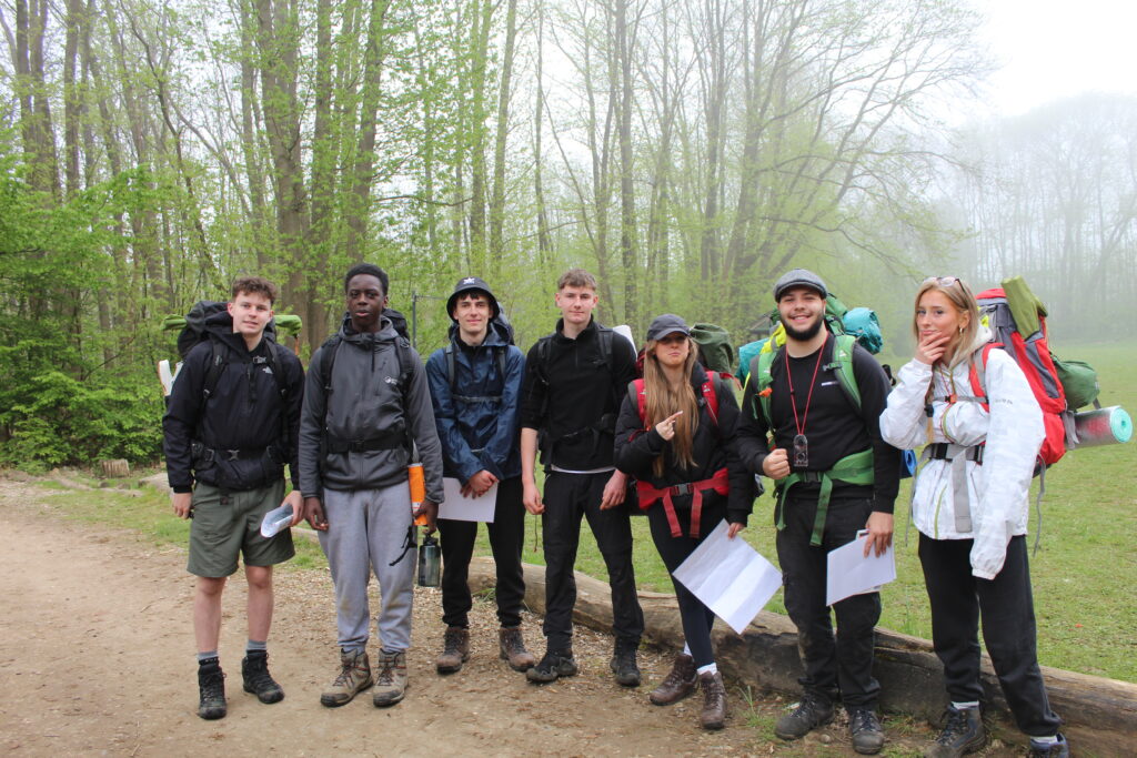 A group of students are pictured posing together for a photo, wearing their backpacks, whilst on a Duke of Edinburgh practice event.