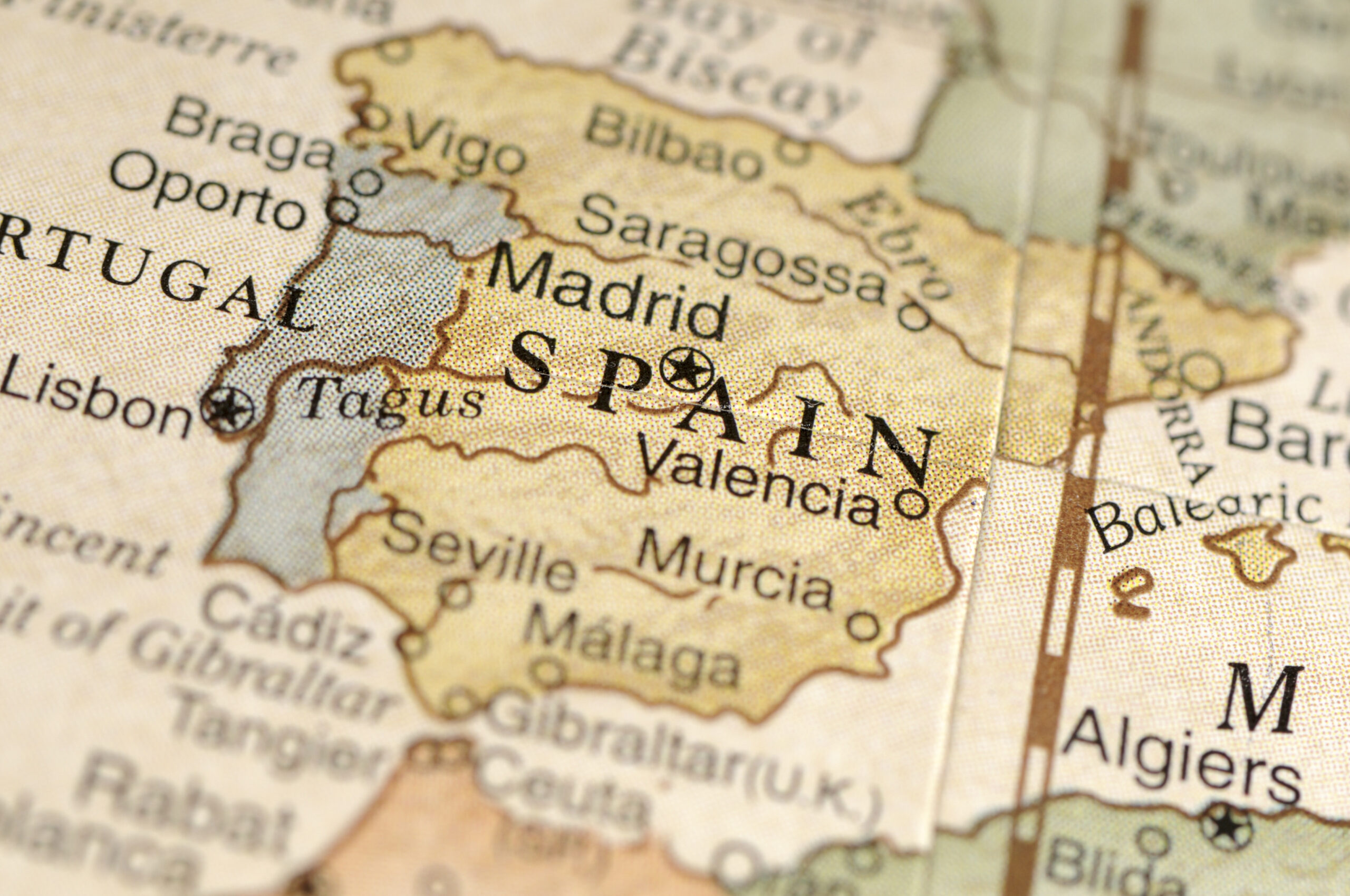 A close-up/macro photograph of Spain from a desktop globe. Adobe RGB color profile.